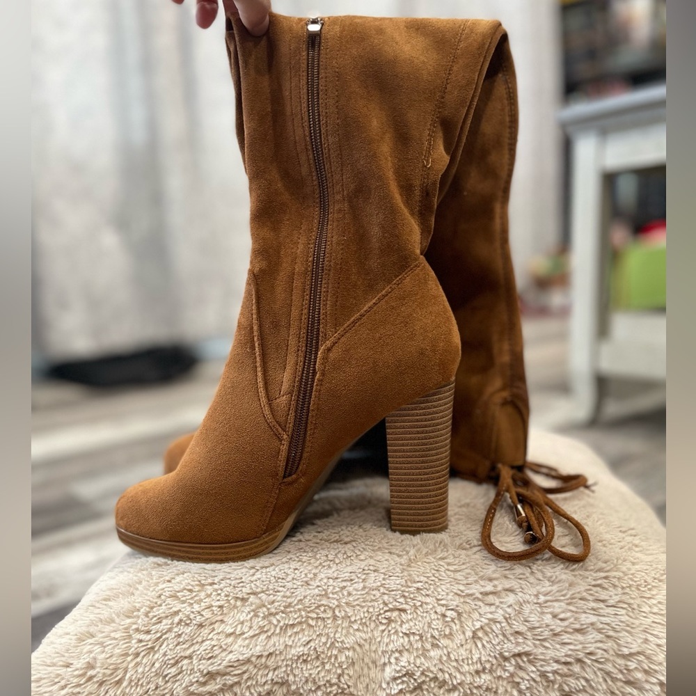 Burnt orange/brown over the knee suede high heeled boots.